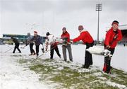 26 December 2010; Ulster Rugby Academy players start removing the snow from the Ravenhill pitch ahead of Ulster's Celtic League clash against Leinster, on Monday 27th December. Ravenhill, Belfast, Antrim. Picture credit: John Dickson / SPORTSFILE