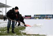 26 December 2010; Ulster Team Doctor Michael Webb helps the remove the snow from the Ravenhill pitch ahead of Ulster's Celtic League clash against Leinster, on Monday 27th December. Ravenhill, Belfast, Antrim. Picture credit: John Dickson / SPORTSFILE