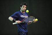 27 December 2010; Niall Fitzgerald, Greystones, Co. Wicklow, chooses which ball to use before serving to Peter Bothwell. Babolat National Indoor Tennis Championships, David Lloyd Riverview, Clonskeagh, Dublin. Picture credit: Barry Cregg / SPORTSFILE