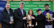 29 December 2010; Winning owners of Majestic Concorde Dr. Ronan Lambe and his wife Anne are presented with the Paddy Power Steeplechase Cup, in the company of trainer Dermot Weld and jockey Robbie McNamara. Leopardstown Christmas Racing Festival 2010, Leopardstown Racecourse, Leopardstown, Dublin. Picture credit: Stephen McCarthy / SPORTSFILE