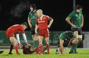27 December 2010; Munster's Alan Quinlan, is assisted by team-mate Ronan O'Gara after dislocating his elbow. Celtic League, Connacht v Munster, Sportsground, Galway. Picture credit: Diarmuid Greene / SPORTSFILE