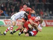 1 January 2011; Denis Leamy, Munster, loses the ball in contact with Paddy Wallace, left, and Luke Marshall, Ulster. Celtic League, Munster v Ulster, Thomond Park, Limerick. Picture credit: Brendan Moran / SPORTSFILE