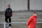9 January 2011; Mayo manager James Horan and a lone supporter watch on during a Mayo training session after the match was postponed by referee TJ Keavney who deemed the pitch unplayable. FBD Connacht League, Mayo v Leitrim, Sean O'Heslin Park, Ballyhaunis GAA Club, Ballyhaunis, Co Mayo. Picture credit: Brian Lawless / SPORTSFILE