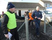 9 January 2011; A steward holds the gate open as the new Galway manager Thomas O' Flatharta walks towards the pitch. FBD Connacht League, Sligo v Galway, Enniscrone, Sligo. Picture credit: Ray Ryan / SPORTSFILE