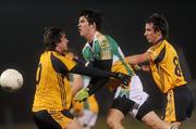 12 January 2011; Richie Dalton, Offaly, in action against Fionn O'Shea, right, and David Kinnan, DCU. O'Byrne Cup, Offaly v DCU, Rhode, Co. Offaly. Picture credit: Brian Lawless / SPORTSFILE