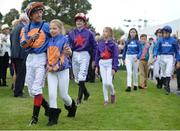 10 September 2016; Jockeys including Frankie Dettori are led into the parade ring by mascots ahead of the QIPCO Irish Champion Stakes  on Almanzor at Leopardstown Racecourse in Dublin. Photo by Cody Glenn/Sportsfile
