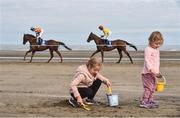 13 September 2016; Emily Maher, left, age 7, and her sister Lilly, age 2, from Laytown, Co Meath, play in the sand during the Laytown Races in Laytown, Co Meath. Photo by David Maher/Sportsfile