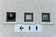 16 January 2011; Wexford's Aindreas Doyle, who plays his club football with Dublin club Parnells, looks out a dressing room window as his team-mates warm up, on the pitch, before the game. O'Byrne Shield, Dublin v Wexford, Parnell Park, Donnycarney, Dublin. Picture credit: Ray McManus / SPORTSFILE