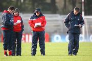 23 January 2011; Cork manager Denis Walsh, right, checks the team lineups before throw-in. Waterford Crystal Cup Quarter-Final, Cork v UCC, Pairc Ui Rinn, Cork. Picture credit: Ken Sutton / SPORTSFILE