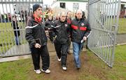 23 January 2011; Tyrone manager Mickey Harte, centre, makes his way on to the field with Dermot McCaughey, Tyrone assistant secretary, left, and Damien Harvey, Tyrone PRO. Barrett Sports Lighting Dr. McKenna Cup Section A, Tyrone v Donegal, Edendork, Co. Tyrone. Picture credit: Oliver McVeigh / SPORTSFILE
