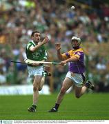 16 September 2001; Limerick's Peter Lawlor gets a pass away despite the attentions of Wexford's Darren Stamp. Limerick v Wexford, All-Ireland U-21 Hurling Final, Semple Stadium, Thurles. Picture credit; Brendan Moran / SPORTSFILE