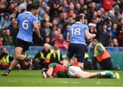 18 September 2016; Evan Regan of Mayo lies injured as Denis Bastick of Dublin clears the balls during the closing stages of the GAA Football All-Ireland Senior Championship Final match between Dublin and Mayo at Croke Park in Dublin. Photo by David Maher/Sportsfile
