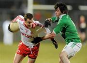 26 January 2011; Brian McGuigan, Tyrone, in action against Barry Mulrone, Fermanagh. Barrett Sports Lighting Dr. McKenna Cup Section A, Fermanagh v Tyrone, Brewster Park, Enniskillen, Co. Fermanagh. Picture credit: Oliver McVeigh / SPORTSFILE