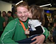 21 September 2016; Noelle Lenihan of Ireland, from Charleville, Co Cork, who won bronze in the f38 discus, gets a kiss from her neice Kendal Ming, age 4, who flew in from Arkansas, USA, during their homecoming from the Rio 2016 Paralympic Games at Dublin Airport in Dublin. Photo by Cody Glenn/Sportsfile