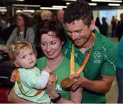 21 September 2016; Cyclist Eoghan Clifford from Galway, shows his gold and bronze medals to his 11-month-old daughter Zofia Clifford and wife Magdalena Hajdukiewicz during their homecoming from the Rio 2016 Paralympic Games at Dublin Airport in Dublin. Photo by Cody Glenn/Sportsfile