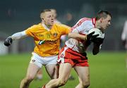 29 January 2011; Brian McCallion, Derry, in action against Paddy Cunningham, Antrim. Barrett Sports Lighting Dr. McKenna Cup Semi-Final, Derry v Antrim, Celtic Park, Derry. Picture credit: Oliver McVeigh / SPORTSFILE