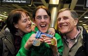 30 January 2011; Team Ireland's Lorraine Whelan, from Delgany, Co. Wicklow, who won gold in the Giant Slalom, with her mother Marie and father Brendan on her return to Dublin Airport following the Special Olympics European Ski Alpine Cup 2011 in Austria. Dublin Airport, Dublin. Picture credit: Brian Lawless / SPORTSFILE