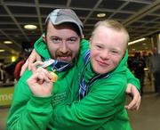 30 January 2011; Team Ireland's Gary Burton, from Sallynoggin, Co. Dublin, left, who won gold in the Giant Slalom and silver in the Slalom, celebrates with Ben Purcell, from Dalkey, Co. Dublin, who came fourth in the Giant Slalom and fouth in the Slalom, on their return to Dublin Airport following the Special Olympics European Ski Alpine Cup 2011 in Austria. Dublin Airport, Dublin. Picture credit: Brian Lawless / SPORTSFILE