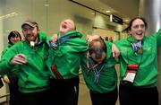 30 January 2011; Team Ireland members, from left, Gary Burton, from Sallynoggin, Co. Dublin, who won gold in the Giant Slalom and silver in the Slalom, Ben Purcell, from Dalkey, Co. Dublin, who came fourth in the Giant Slalom and fourth in the Slalom, Cormac Maguire, from Ballinteer, Co. Dublin, who won gold in the Slalom and fourth in the Giant Slalom, and Lorraine Whelan, from Delgany, Co. Wicklow, who won gold in the Giant Slalom, on their return to Dublin following the Special Olympics European Ski Alpine Cup 2011 in Austria. Dublin Airport, Dublin. Picture credit: Brian Lawless / SPORTSFILE