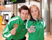 31 January 2011; Ireland's Catherine Wayland, from New Ross, Co. Wexford, who won Gold in the Women's Discus F51 and Silver in the Women's Club Throw with Michael McKillop, from Co. Antrim, who won a Gold Medal after winning the Men's 800m T37 and also won the 1,500m final on their arrival into Dublin following the 2011 IPC Athletics World Championships in New Zealand. Dublin Airport, Dublin. Picture credit: Ray McManus / SPORTSFILE