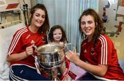 26 September 2016; Áine McInerney, age 4, from Mountainpole, Kells, in Meath, and Cork players Eimear Meaney, left, and Maeve O'Sullivan with the Brendan Martin cup during a visit to Temple Street Children's Hospital, in Dublin. Photo by Piaras Ó Mídheach/Sportsfile