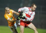 29 January 2011; Ciaran McGoldrick, Derry, in action against Mark McAleese, Antrim. Barrett Sports Lighting Dr. McKenna Cup Semi-Final, Derry v Antrim, Celtic Park, Derry. Picture credit: Oliver McVeigh / SPORTSFILE