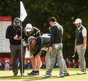 29 September 2016; Players and Caddys including Rory McIlroy and Andy Sullivan of Europe look into the fifth hole after Rory's ball went straight in from the fairway during a practice session ahead of The 2016 Ryder Cup Matches at the Hazeltine National Golf Club in Chaska, Minnesota, USA. Photo by Ramsey Cardy/Sportsfile