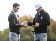 29 September 2016; Europe vice-captain Padraig Harrington hands cash to Martin Kaymer of Europe at the end of the round during a practice session ahead of The 2016 Ryder Cup Matches at the Hazeltine National Golf Club in Chaska, Minnesota, USA. Photo by Ramsey Cardy/Sportsfile