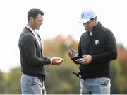 29 September 2016; Europe vice-captain Padraig Harrington hands cash to Martin Kaymer of Europe at the end of the round during a practice session ahead of The 2016 Ryder Cup Matches at the Hazeltine National Golf Club in Chaska, Minnesota, USA. Photo by Ramsey Cardy/Sportsfile