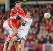 6 February 2011; Gerard O'Kane, Derry, in action against Brian McGuigan and Stephen O'Neill, Tyrone. Allianz Football League Division 2 Round 1, Derry v Tyrone, Celtic Park, Derry. Picture credit: Oliver McVeigh  / SPORTSFILE