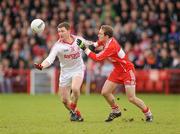 6 February 2011; Enda McGinley, Tyrone, in action against Sean Leo McGoldrick, Derry. Allianz Football League Division 2 Round 1, Derry v Tyrone, Celtic Park, Derry. Picture credit: Oliver McVeigh  / SPORTSFILE