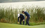 30 September 2016; Rory McIlroy and Andy Sullivan of Europe look for their ball at the 7th green during the morning Foursomes Match against Phil Mickelson and Rickie Fowler of USA at The 2016 Ryder Cup Matches at the Hazeltine National Golf Club in Chaska, Minnesota, USA. Photo by Ramsey Cardy/Sportsfile