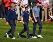 30 September 2016 Europe team captain Darren Clarke, left, in conversation with Rory McIlroy, centre, and Thomas Pieters of Europe on the 8th hole during the afternoon Fourball Match against Dustin Johnson and Matt Kuchar of USA at The 2016 Ryder Cup Matches at the Hazeltine National Golf Club in Chaska, Minnesota, USA. Photo by Ramsey Cardy/Sportsfile