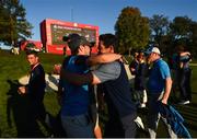 30 September 2016; Niall Horan congratulates Rory McIlroy of Europe after winning his Fourball Match on the 16th hole against Dustin Johnson and Matt Kuchar of USA at The 2016 Ryder Cup Matches at the Hazeltine National Golf Club in Chaska, Minnesota, USA. Photo by Ramsey Cardy/Sportsfile