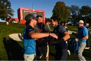 30 September 2016; Niall Horan congratulates Rory McIlroy of Europe after winning his Fourball Match on the 16th hole against Dustin Johnson and Matt Kuchar of USA at The 2016 Ryder Cup Matches at the Hazeltine National Golf Club in Chaska, Minnesota, USA. Photo by Ramsey Cardy/Sportsfile
