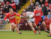 6 February 2011; Brian McGuigan, Tyrone, in action against Sean Leo McGoldrick and Mark Lynch, Derry. Allianz Football League Division 2 Round 1, Derry v Tyrone, Celtic Park, Derry. Picture credit: Oliver McVeigh  / SPORTSFILE