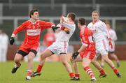 6 February 2011; Brian McGuigan, Tyrone, in action against Mark Lynch and Barry McGoldrick, Derry. Allianz Football League Division 2 Round 1, Derry v Tyrone, Celtic Park, Derry. Picture credit: Oliver McVeigh  / SPORTSFILE
