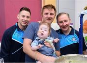 2 October 2016;  Philip McMahon of Dublin, left, Dublin manager Jim Gavin, with Killian Fox, age 15 months, and father Jason Fox from Rossinver, Co Leitrim during their visit to the Temple Street Children's Hospital in Dublin.  Photo by Sam Barnes/Sportsfile