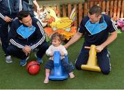 2 October 2016; Milana Commins, age 2, from Dublin, with Shane Carthy, left, and Denis Bastick during the Dublin team's visit to the Our Lady's Children's Hospital in Crumlin, Dublin.  Photo by Piaras Ó Mídheach/Sportsfile