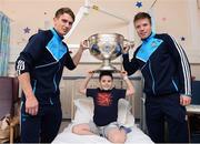 2 October 2016; Dublin players Michael Fitzsimons, left, and Robert McDaid with Mark Lynch, 8, from Cabra, Co Dublin and the Sam Maguire cup during their visit to the Temple Street Children's Hospital in Dublin.  Photo by Sam Barnes/Sportsfile