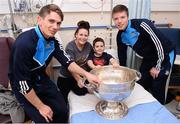 2 October 2016; Dublin players Michael Fitzsimons, left, and Robert McDaid with Mark Lynch, 8, and mother Tracie Carroll, from Cabra, Co Dublin and the Sam Maguire cup during their visit to the Temple Street Children's Hospital in Dublin.  Photo by Sam Barnes/Sportsfile