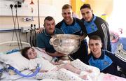 2 October 2016; Dublin players, from left, Jonny Cooper, Shane B. Carthy and Cormac Costello with Poppy Mernagh, 3, and father Edward from Rathnew, Co Wicklow with the Sam Maguire cup during their visit to the Temple Street Children's Hospital in Dublin.  Photo by Sam Barnes/Sportsfile