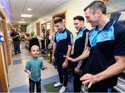 2 October 2016; Dublin players, from left, Cormac Costello, Shane B. Carthy and Denis Bastick with Bogdan Varvara, 8, from Raheny, Co Dublin during their visit to the Temple Street Children's Hospital in Dublin.  Photo by Sam Barnes/Sportsfile