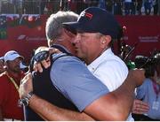 2 October 2016; Europe team captain Darren Clarke, left, and USA captain Davis Love III embrace following USA victory at The 2016 Ryder Cup Matches at the Hazeltine National Golf Club in Chaska, Minnesota, USA. Photo by Ramsey Cardy/Sportsfile