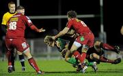 12 February 2011; Fionn Carr, Connacht, is tackled by Rob McCusker, hidden, Martin Roberts, right, and Simon Gardnier, Scarlets. Celtic League, Connacht v Scarlets, Sportsground, Galway. Picture credit: Barry Cregg / SPORTSFILE