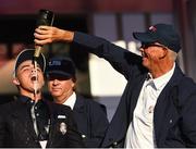 2 October 2016; Rickie Fowler of USA shares a bottle of Champagne with USA vice-captain Tom Lehman at the Closing Ceremony of The 2016 Ryder Cup Matches at the Hazeltine National Golf Club in Chaska, Minnesota, USA. Photo by Ramsey Cardy/Sportsfile