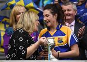 25 September 2016; Mairéad Reynolds of Longford is presented wth the West County Hotel Cup by Marie Hickey, President, LGFA, during the TG4 Ladies Football All-Ireland Junior Football Championship Final match between Antrim and Longford at Croke Park in Dublin. Photo by Brendan Moran/Sportsfile