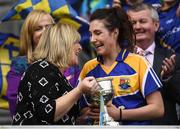 25 September 2016; Mairéad Reynolds of Longford is presented with the West County Hotel Cup by Marie Hickey, President, LGFA, during the TG4 Ladies Football All-Ireland Junior Football Championship Final match between Antrim and Longford at Croke Park in Dublin. Photo by Brendan Moran/Sportsfile