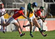 13 February 2011; Conor Mahon, Offaly, has his shot blocked by Shane Murphy, left, supported by Eoin Cadogan, Cork. Allianz Hurling League, Division 1, Round 1, Cork v Offaly, Pairc Uí Chaoimh, Cork. Picture credit: David Maher / SPORTSFILE