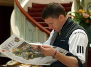 13 October 2001; Ireland's Sean Og De Paor reads the sports pages of a local newspaper in the foyer of the team hotel, The Carlton Crest Hotel, Queens Road, Melbourne, Australia. International Rules  Aust2001. Picture credit; Ray McManus / SPORTSFILE *EDI